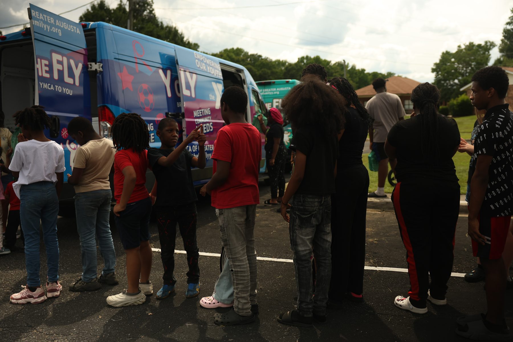 Families gathering for YMCA mobile outreach support